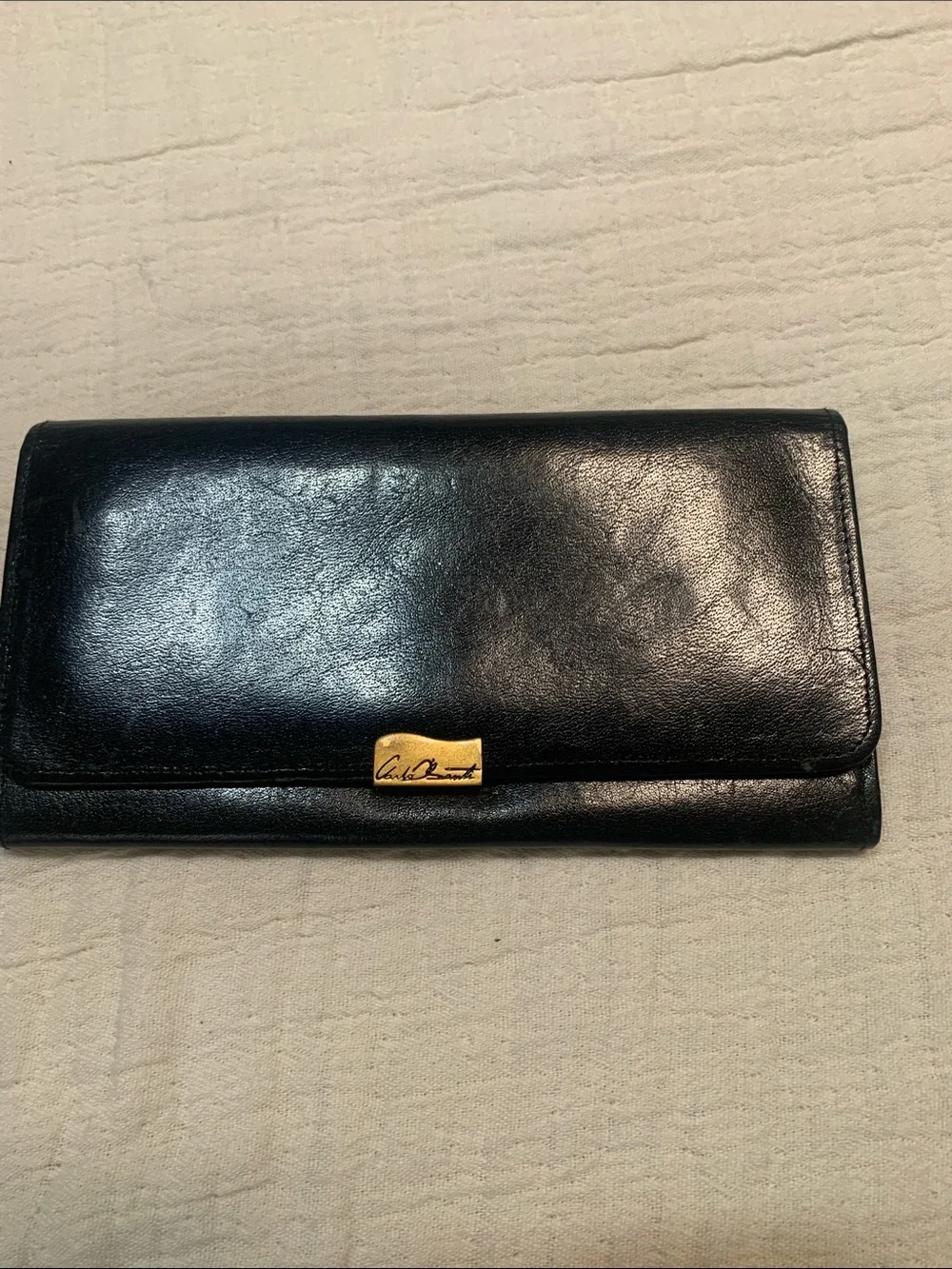 Vintage Carla Banti black leather clutch with signature gold tone plaque
